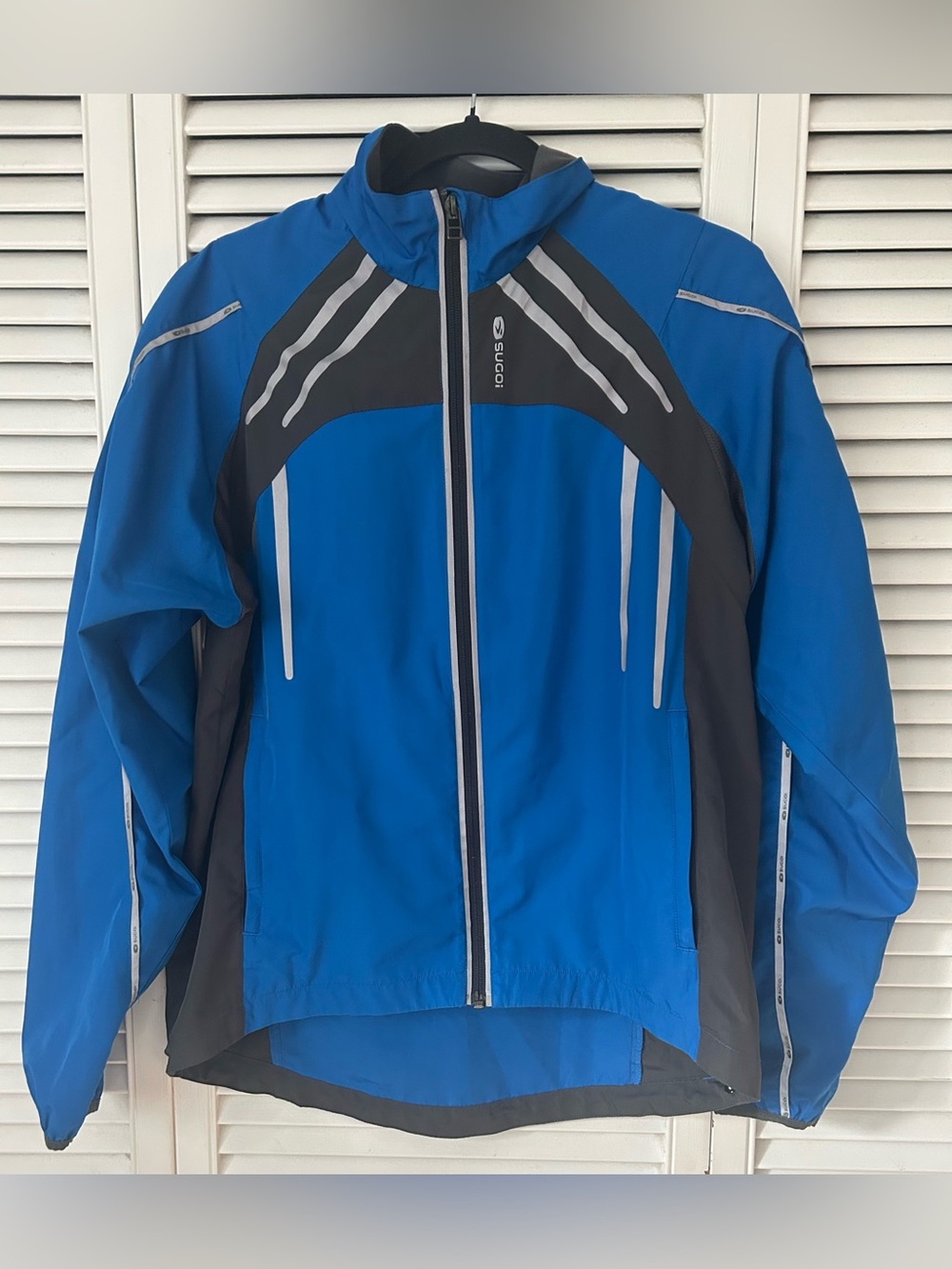 SUGOI Women’s Blue and Black Performance Cycling Jacket with Reflective Stripes